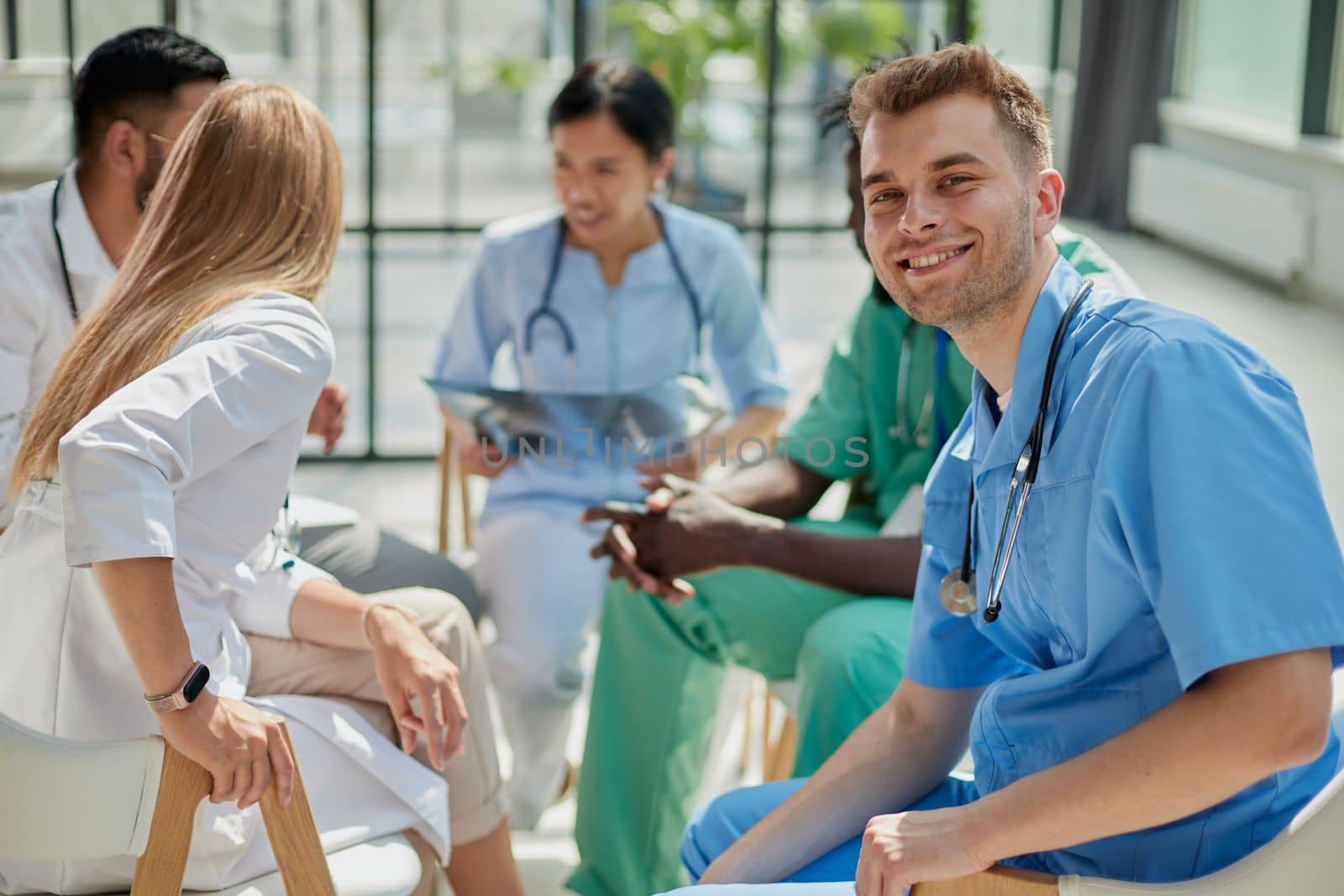 Group of doctors looking at X-ray on medical conference, discussing issues.