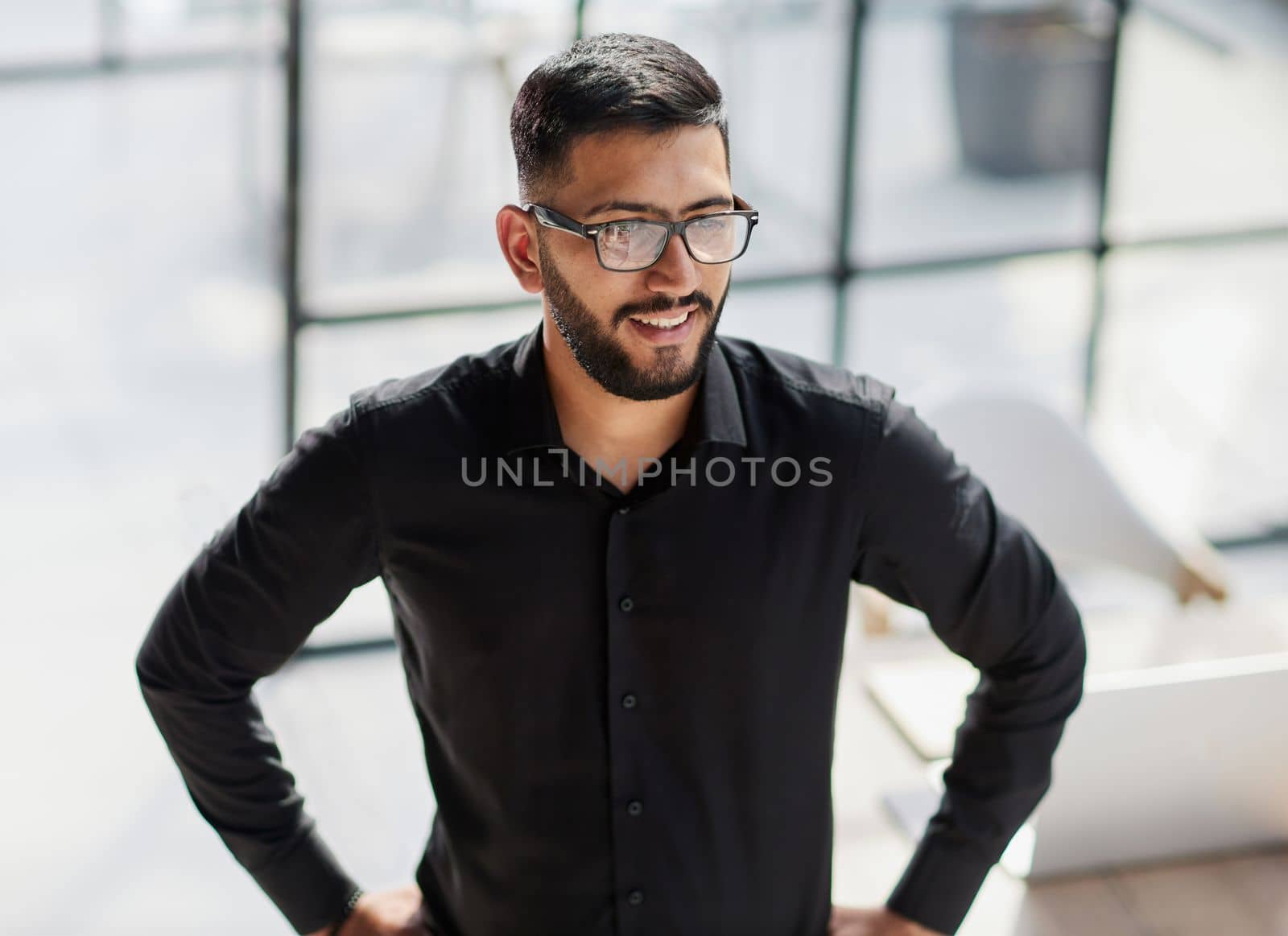 Businessman portrait. Happy confident young businessman standing , smiling, looking at camera.