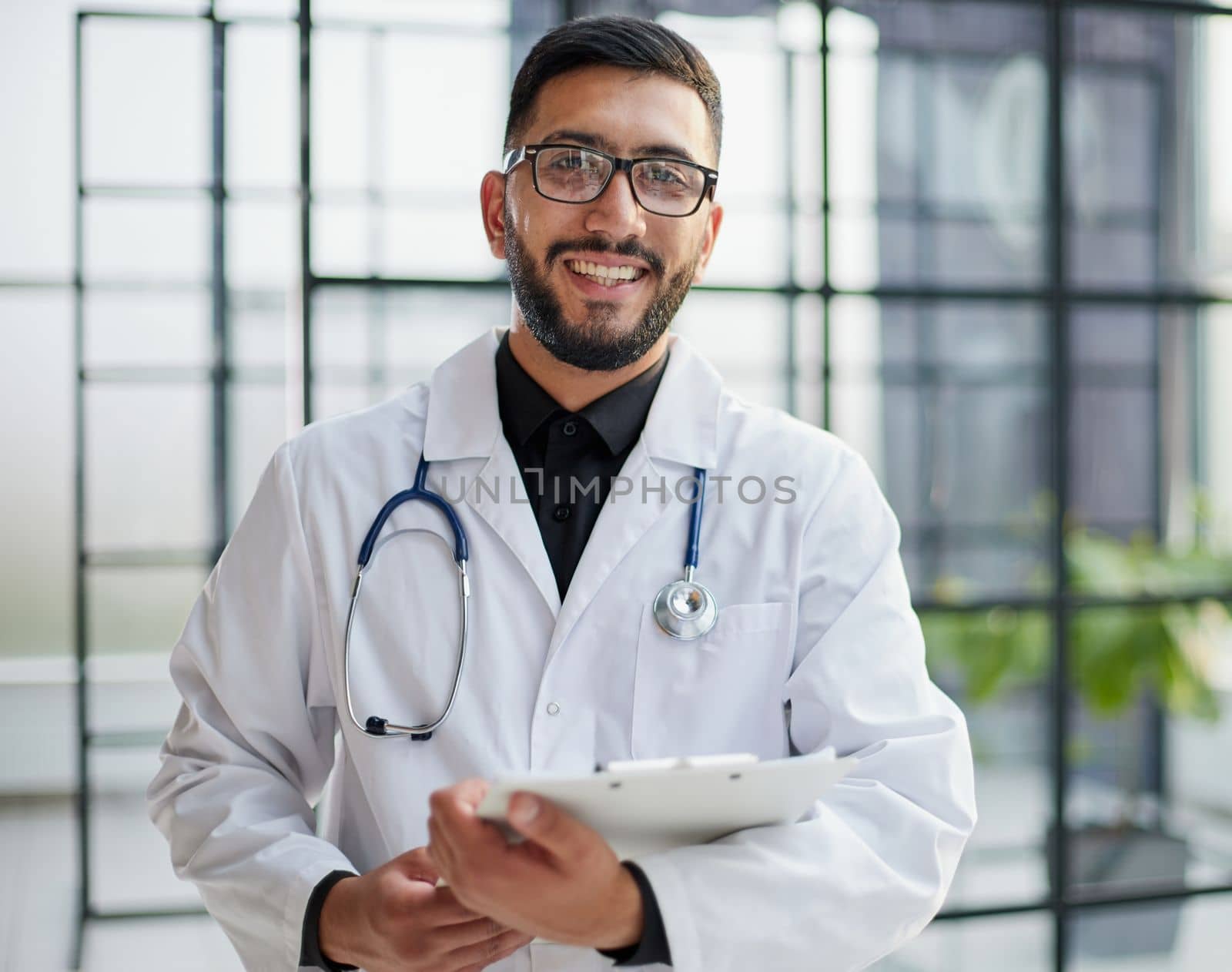 Portrait of male doctor standing with arms crossed