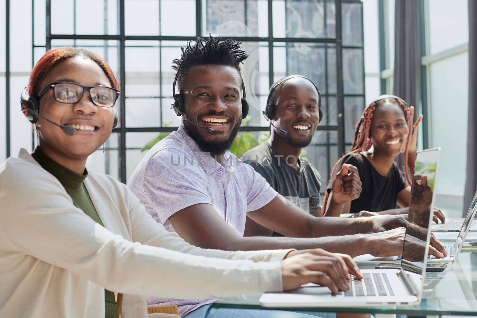 African american team working at call center office to help people with telemarketing assistance by Prosto