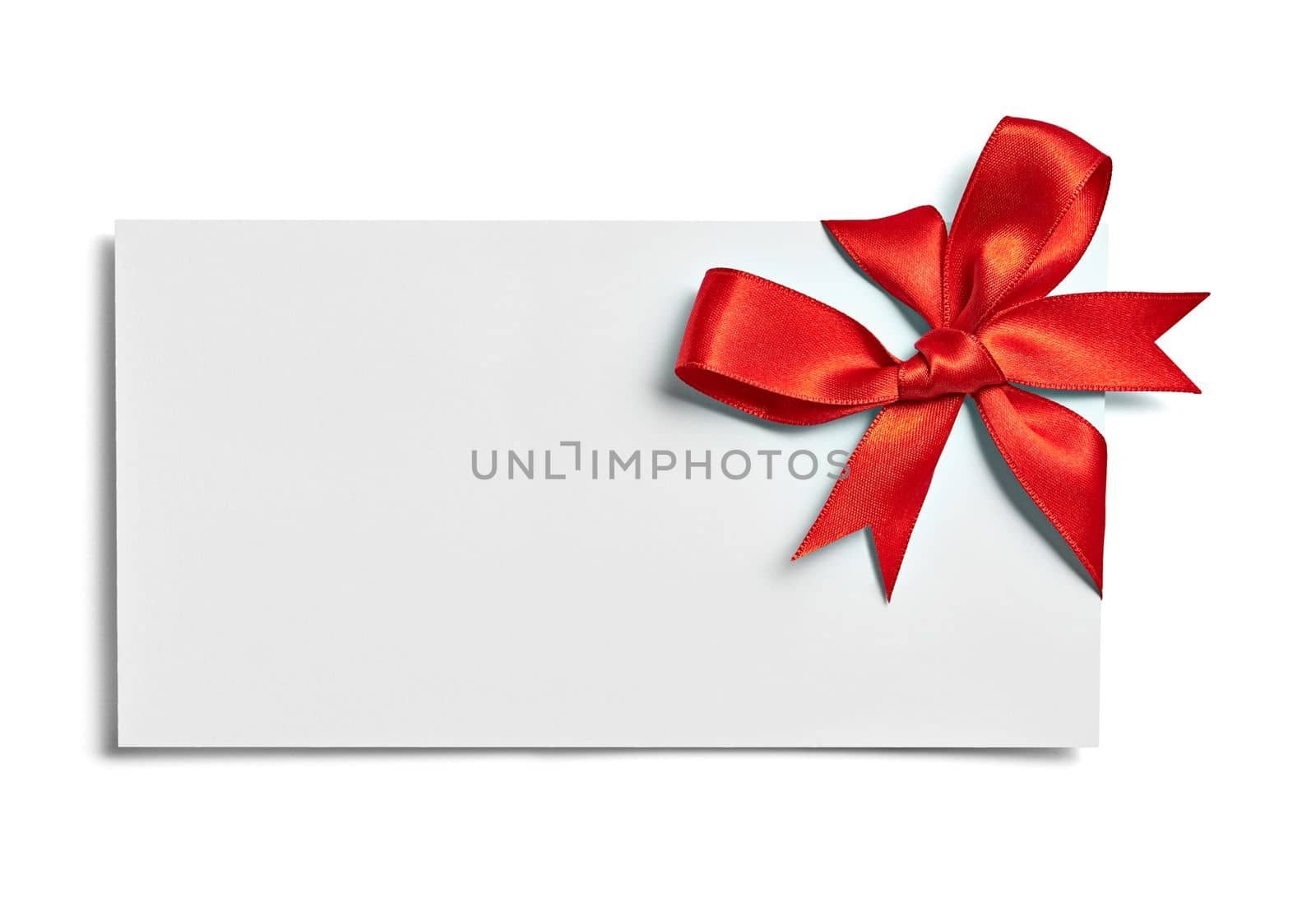 close up of a note card with red ribbon bow on white background