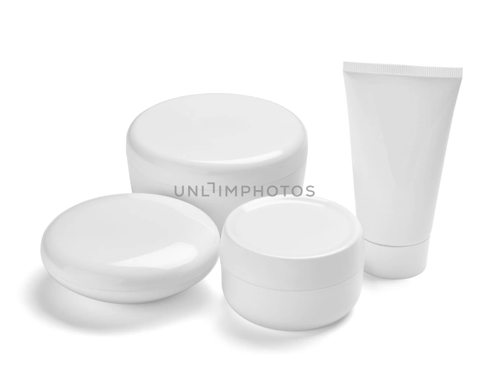 close up of a white beauty cream container and tube on white background