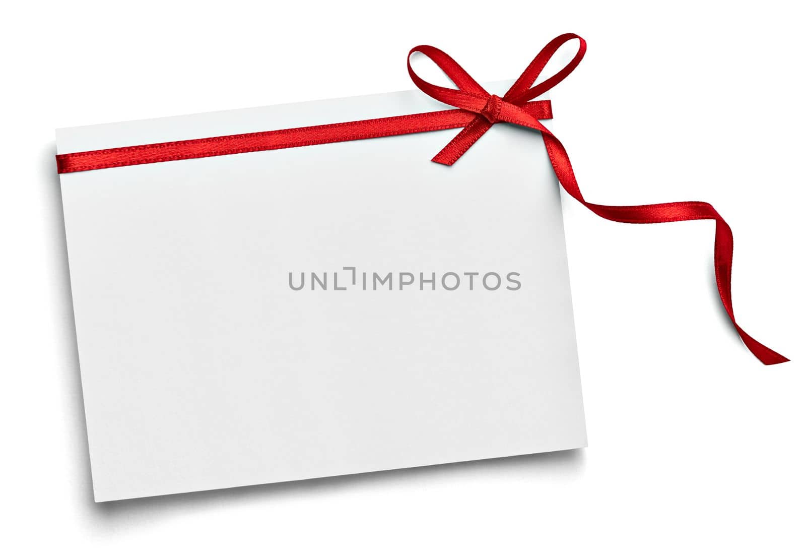 close up of a note card with red ribbon bow on white background