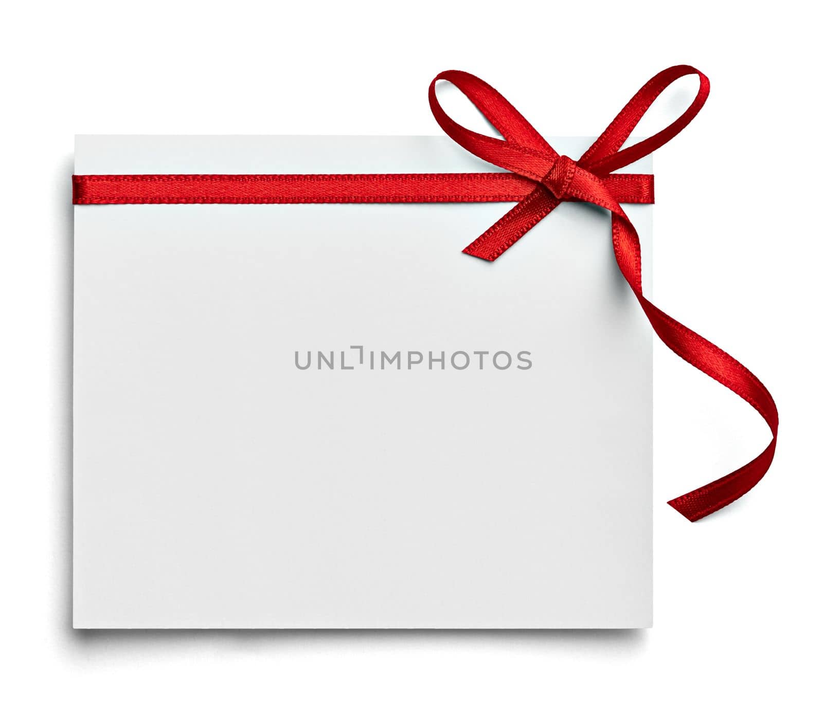 close up of a note card with red ribbon bow on white background