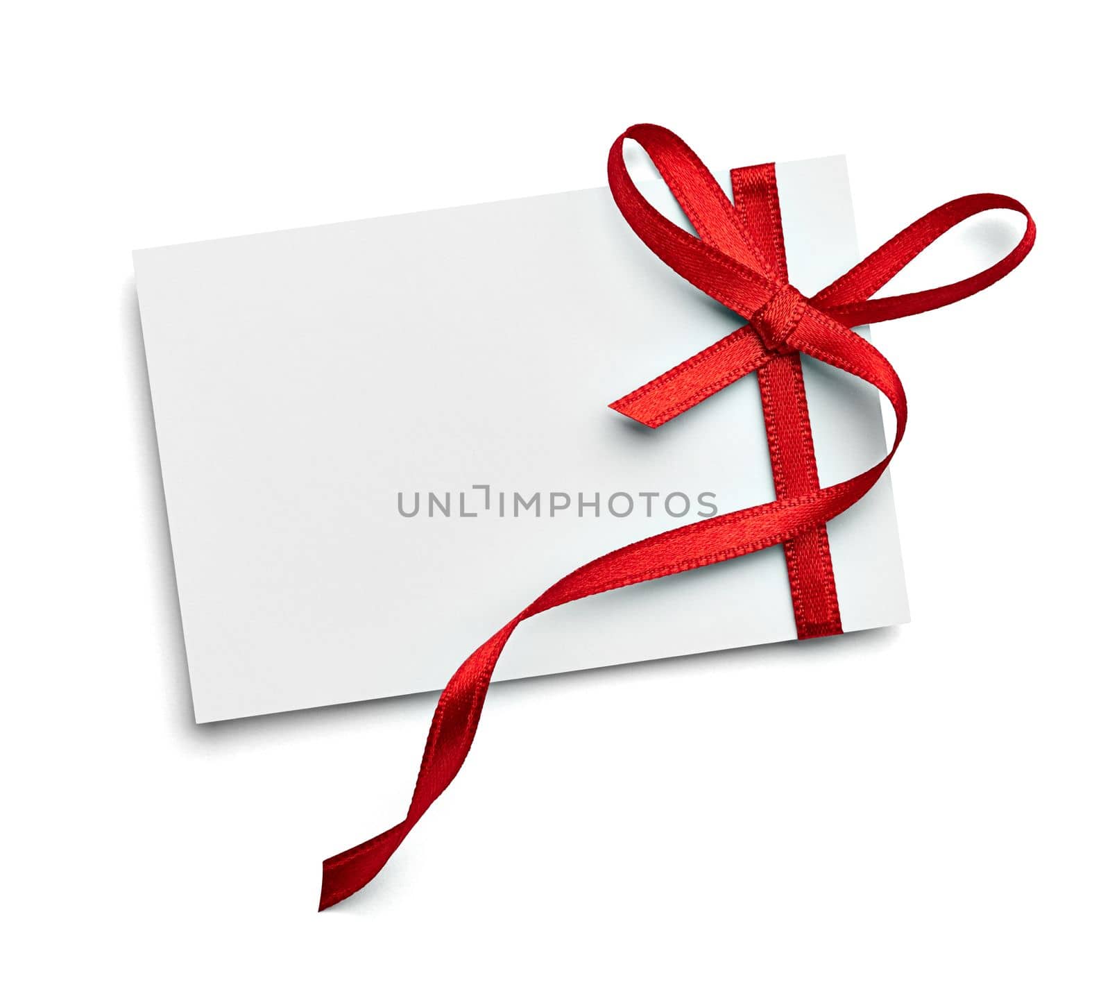 close up of a note card with red ribbon bow on white background