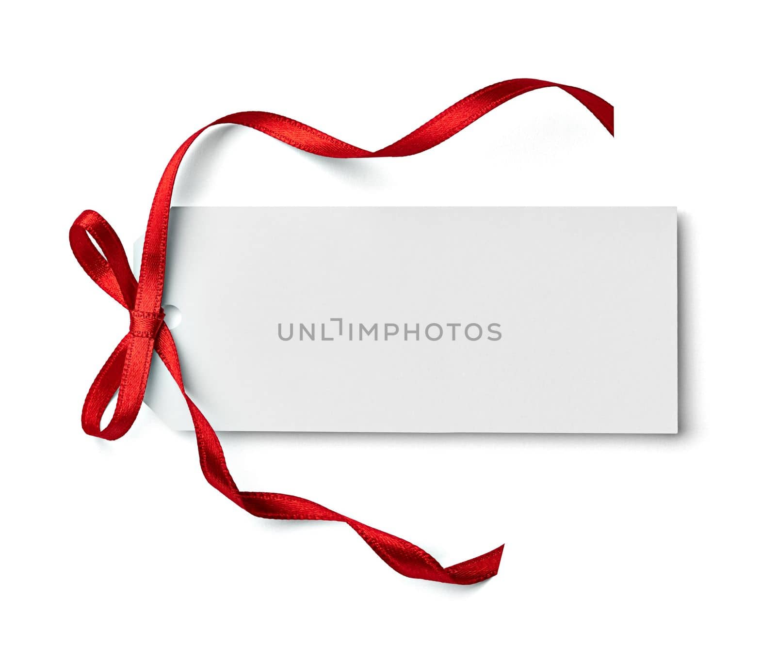 close up of a note card with red ribbon bow on white background