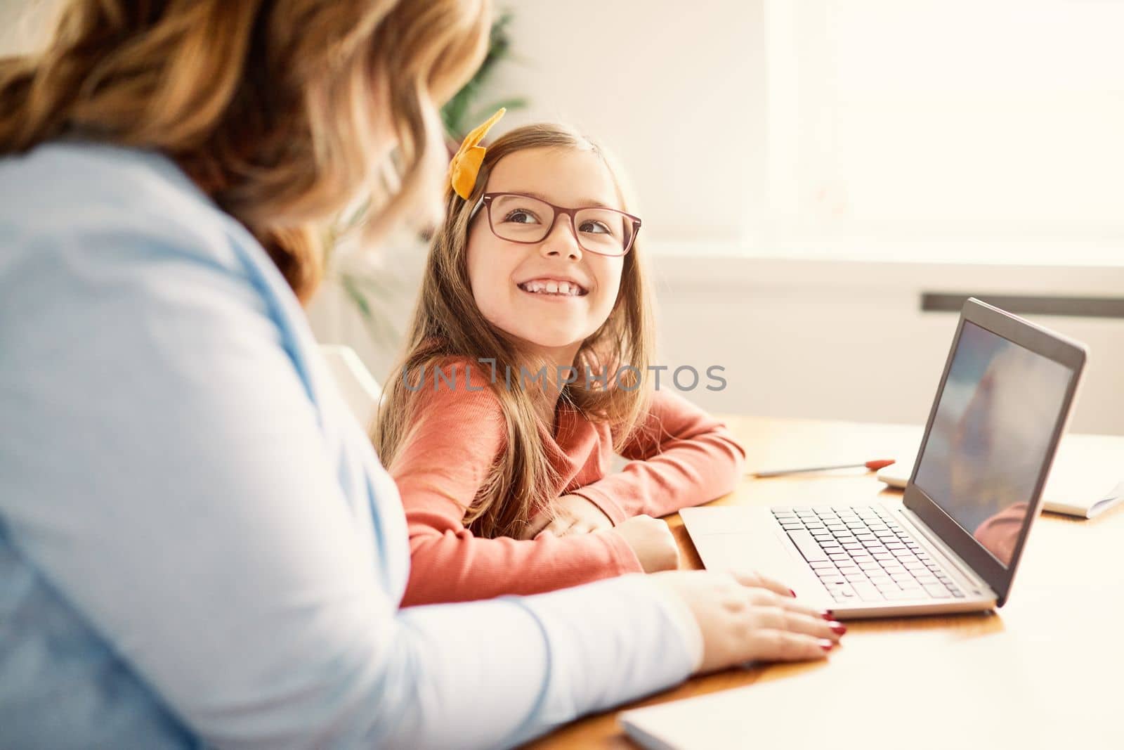 Mother and daughter Having fun with laptop at home