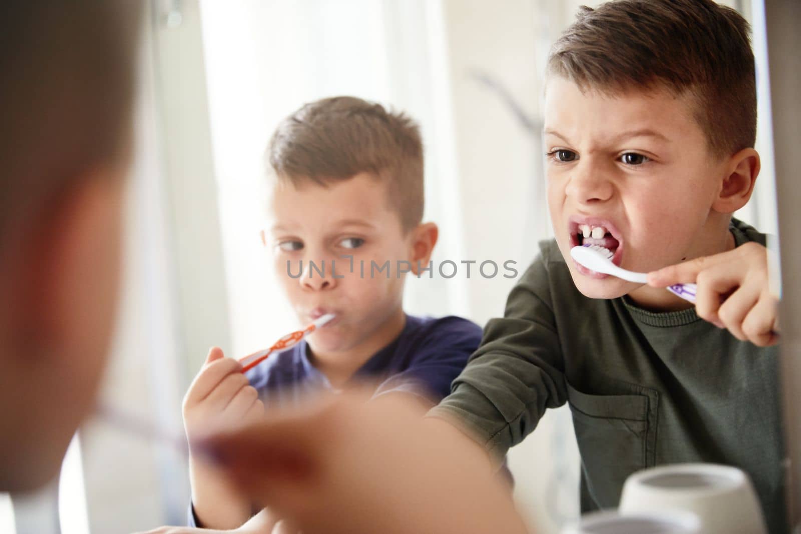 Little cute brothers washing teeth in the bathroom
