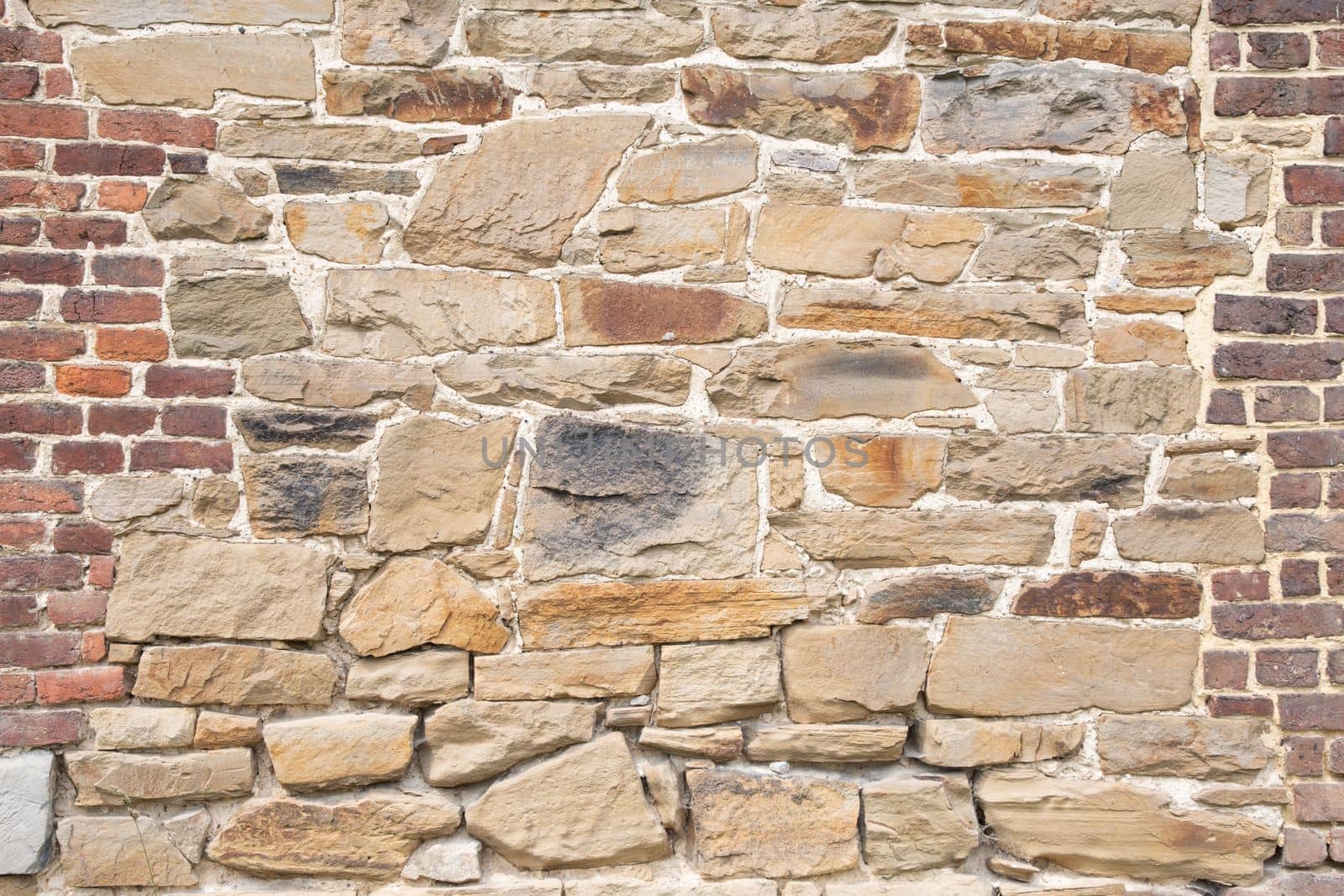 texture of rough masonry yellow rough bricks and cement between them, stone wall High quality photo