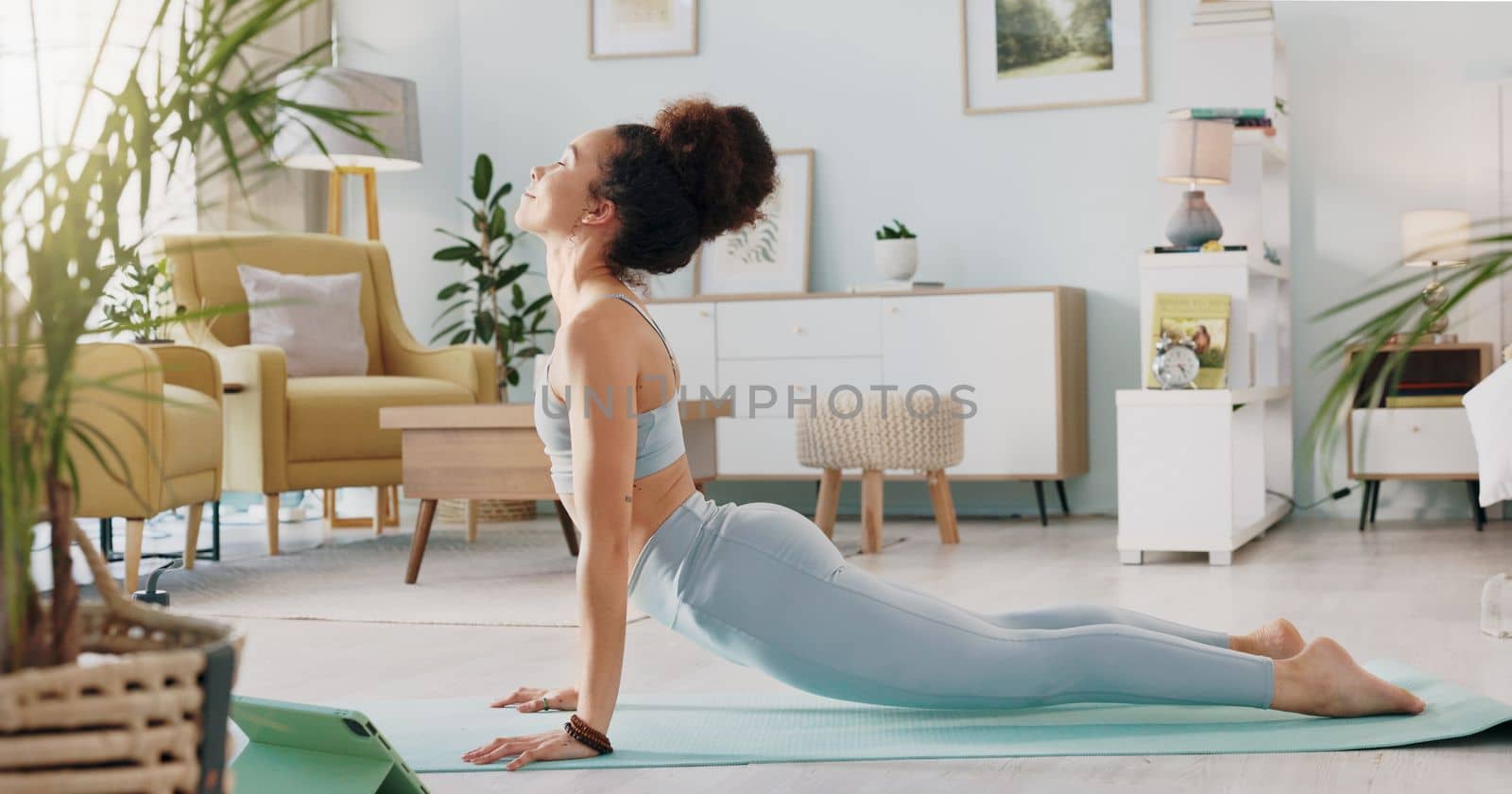 Fitness, yoga or meditation stretching woman for workout in the living room of her house. Girl with chakra focus, mindset or balance while training, exercise or health with zen pilates for wellness. by YuriArcurs