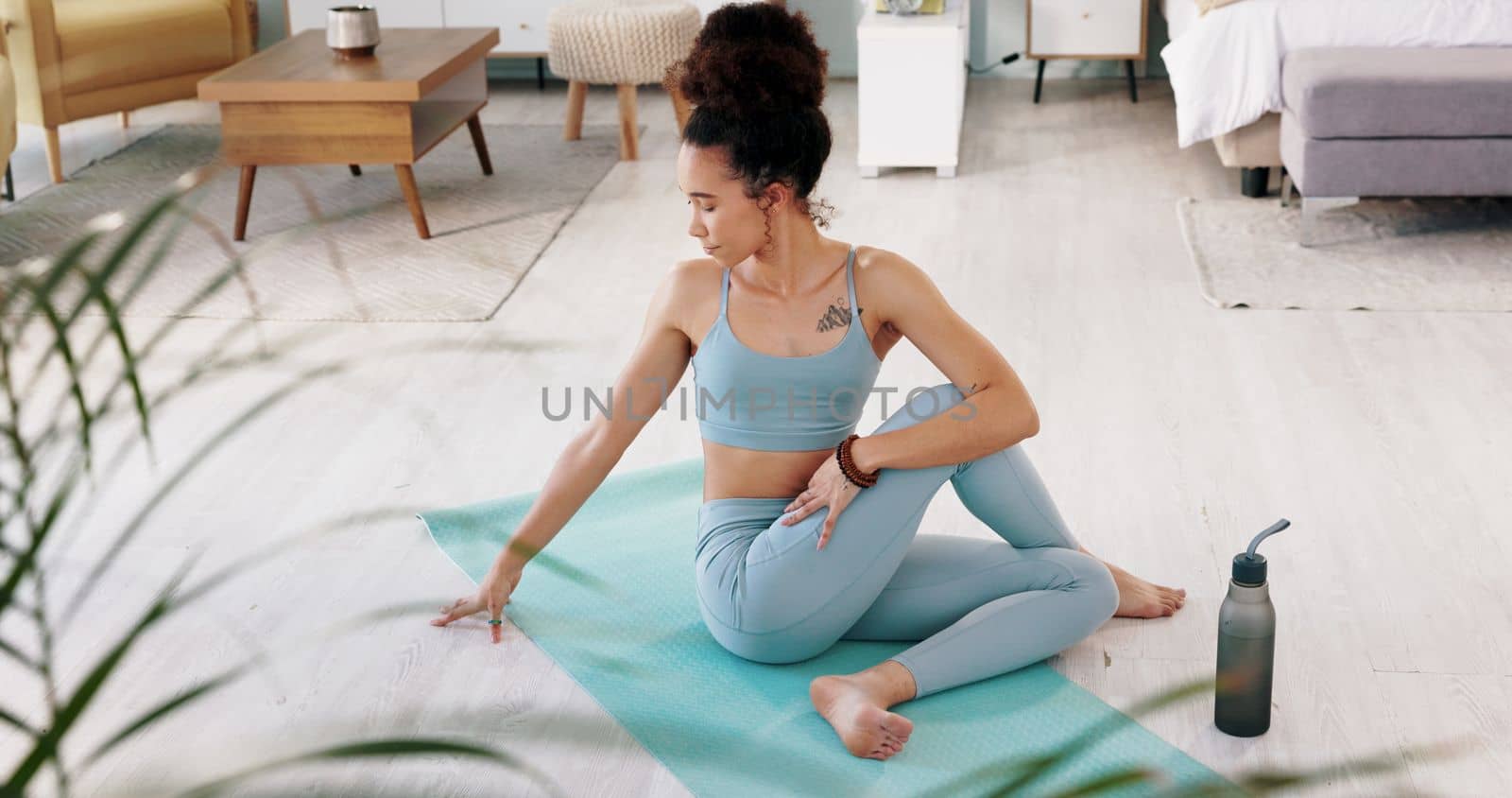 Fitness, yoga or meditation stretching woman for workout in the living room of her house. Girl with chakra focus, mindset or balance while training, exercise or health with zen pilates for wellness