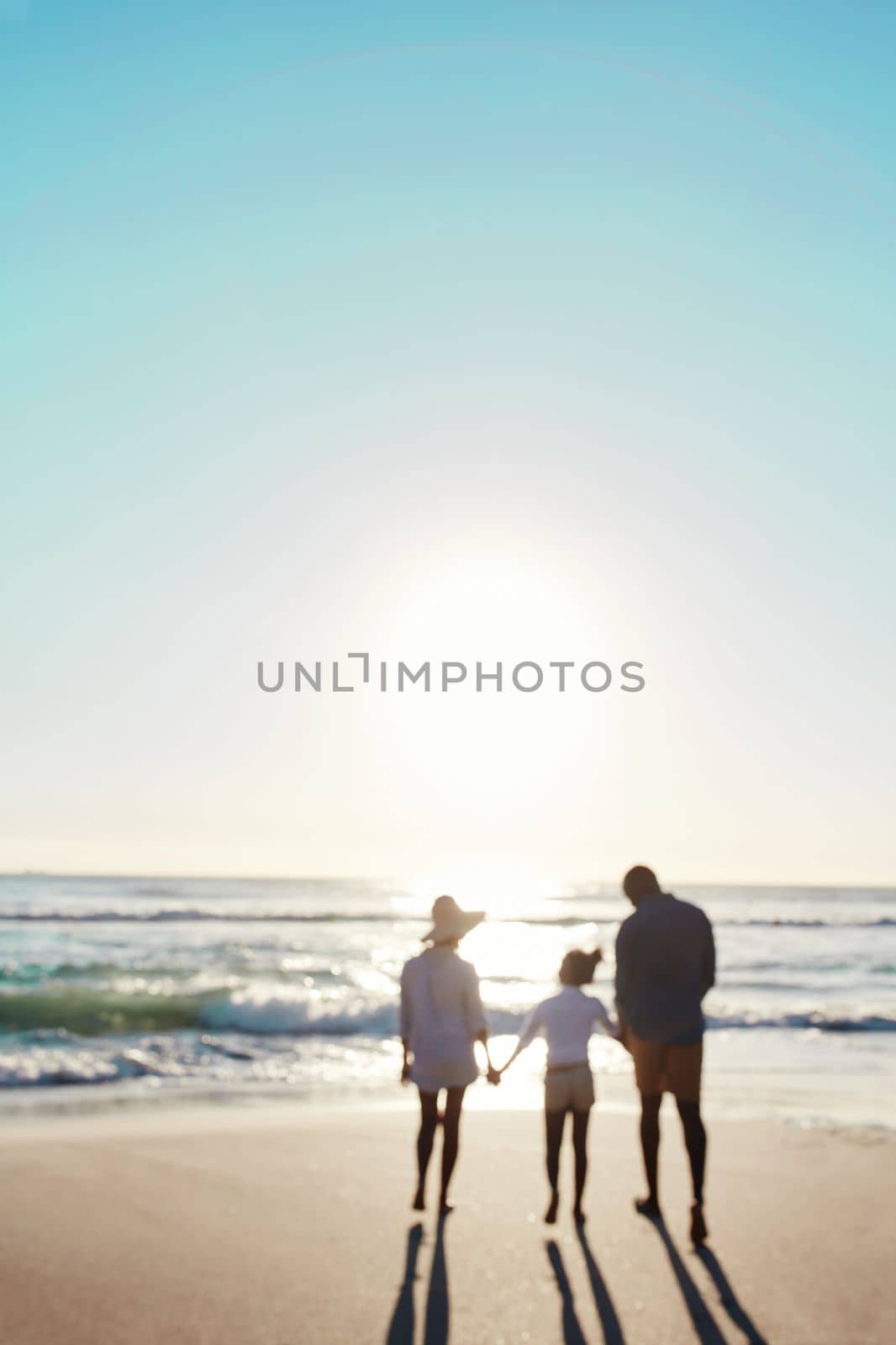 Family, beach and sunset walk during summer on vacation or holiday relaxing at a peaceful scenery at the ocean. Mockup, blurred and parents with daughter, child or kid with childhood freedom at sea.