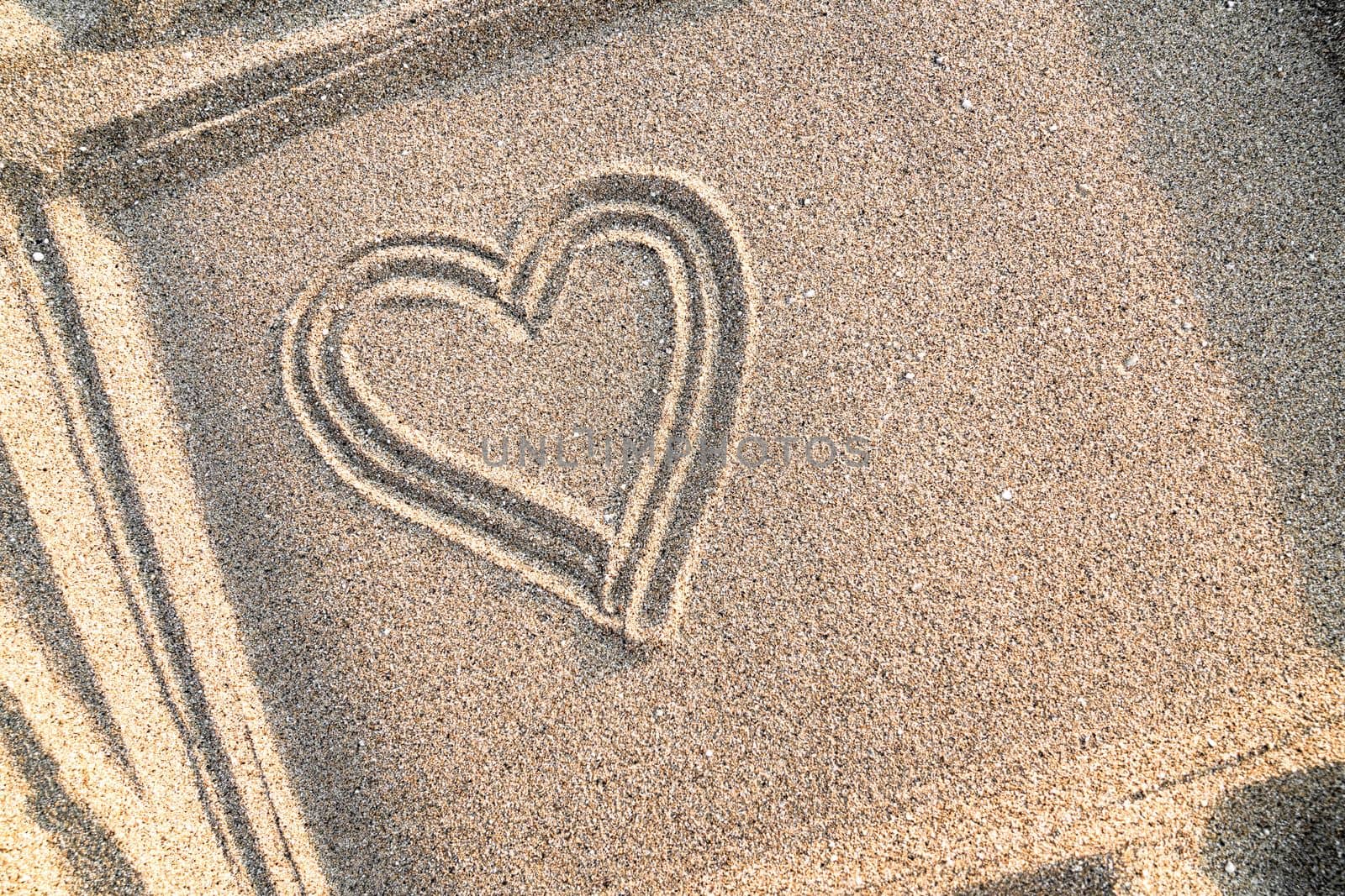 Background with painted heart on sand, concept of love, top view, copy space