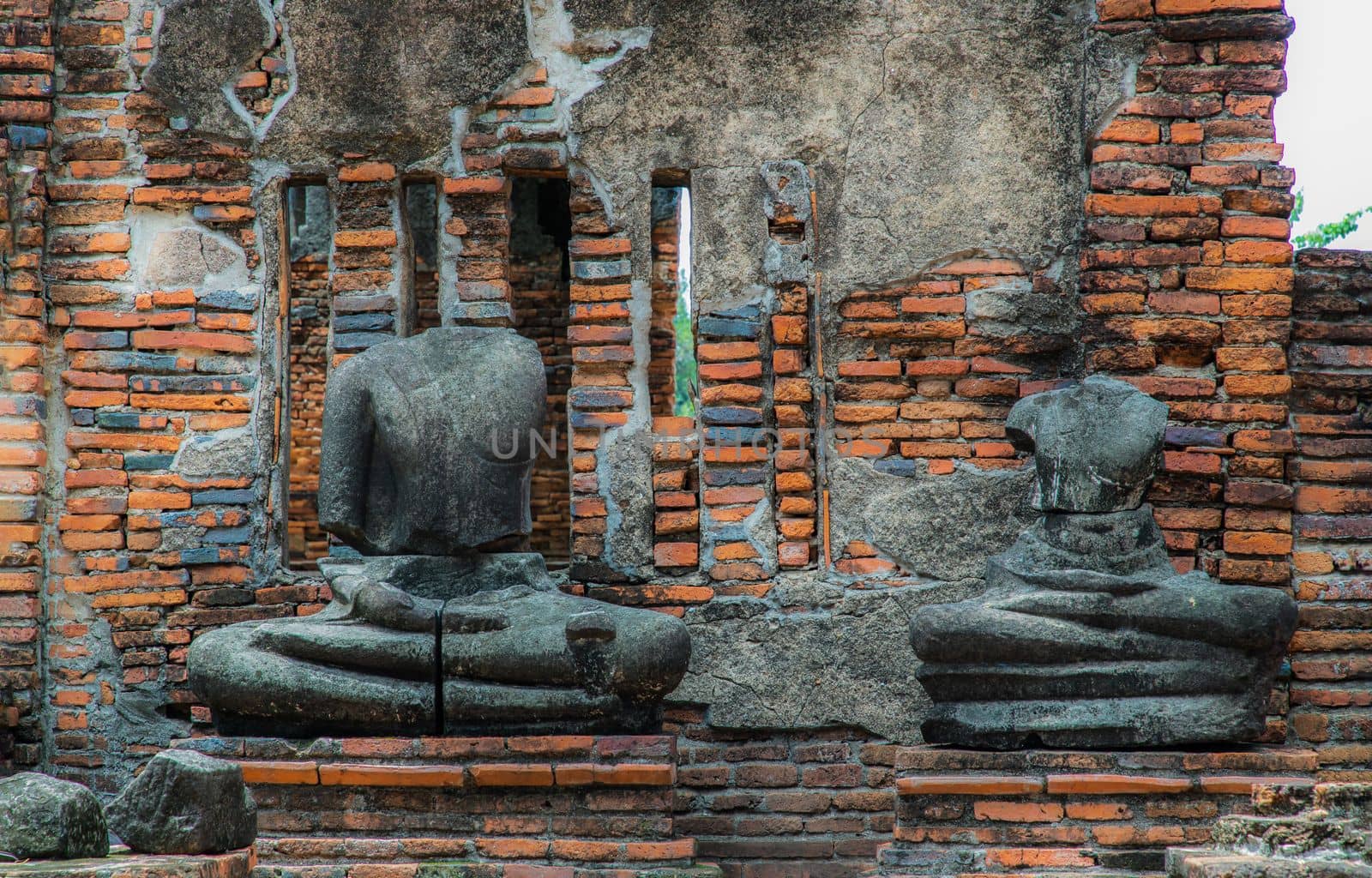 Aytthaya, Thailand, 22 Aug 2020 : Ancient old buddha statue sculpture is damaged at the old temple in Ayuthaya province, thailand. Selective focus.