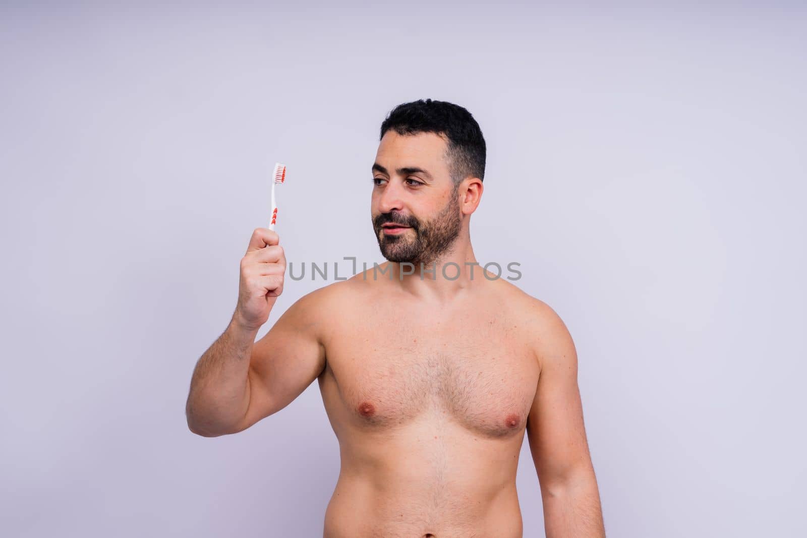 Brush teeth everyday. Masculine model happy to care of oral hygiene, toothbrush, Sanitary concept by Zelenin
