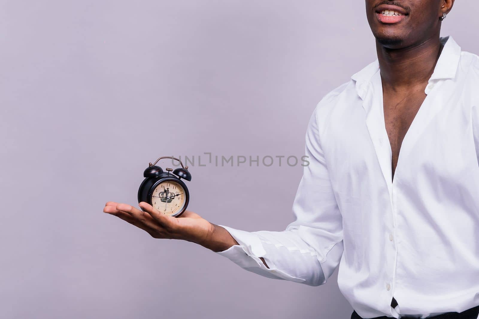 Smiling young african american man 20s wearing casual shirt eyeglasses cap standing studio portrait by Zelenin