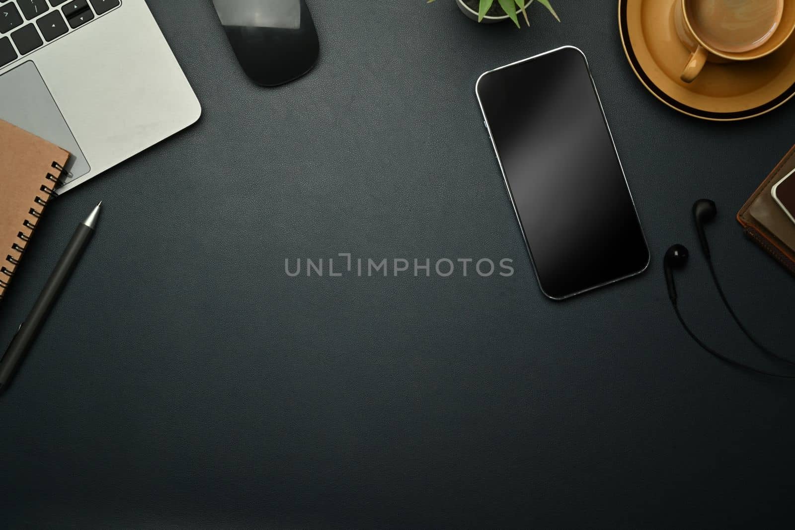 Top view of smart phone, laptop, mouse and cup of coffee on black leather background. Copy space for your text by prathanchorruangsak