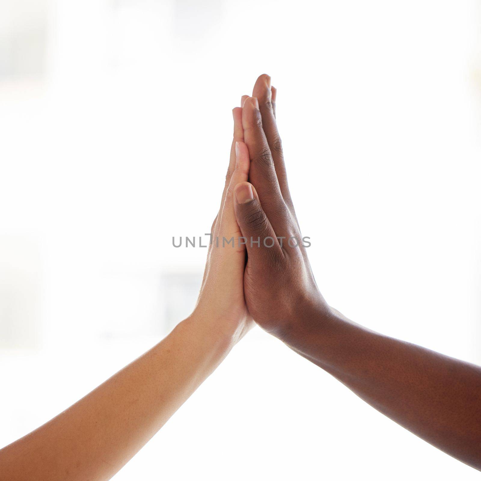 When we stand together we become stronger. an unrecognisable man and woman joining hands a light background