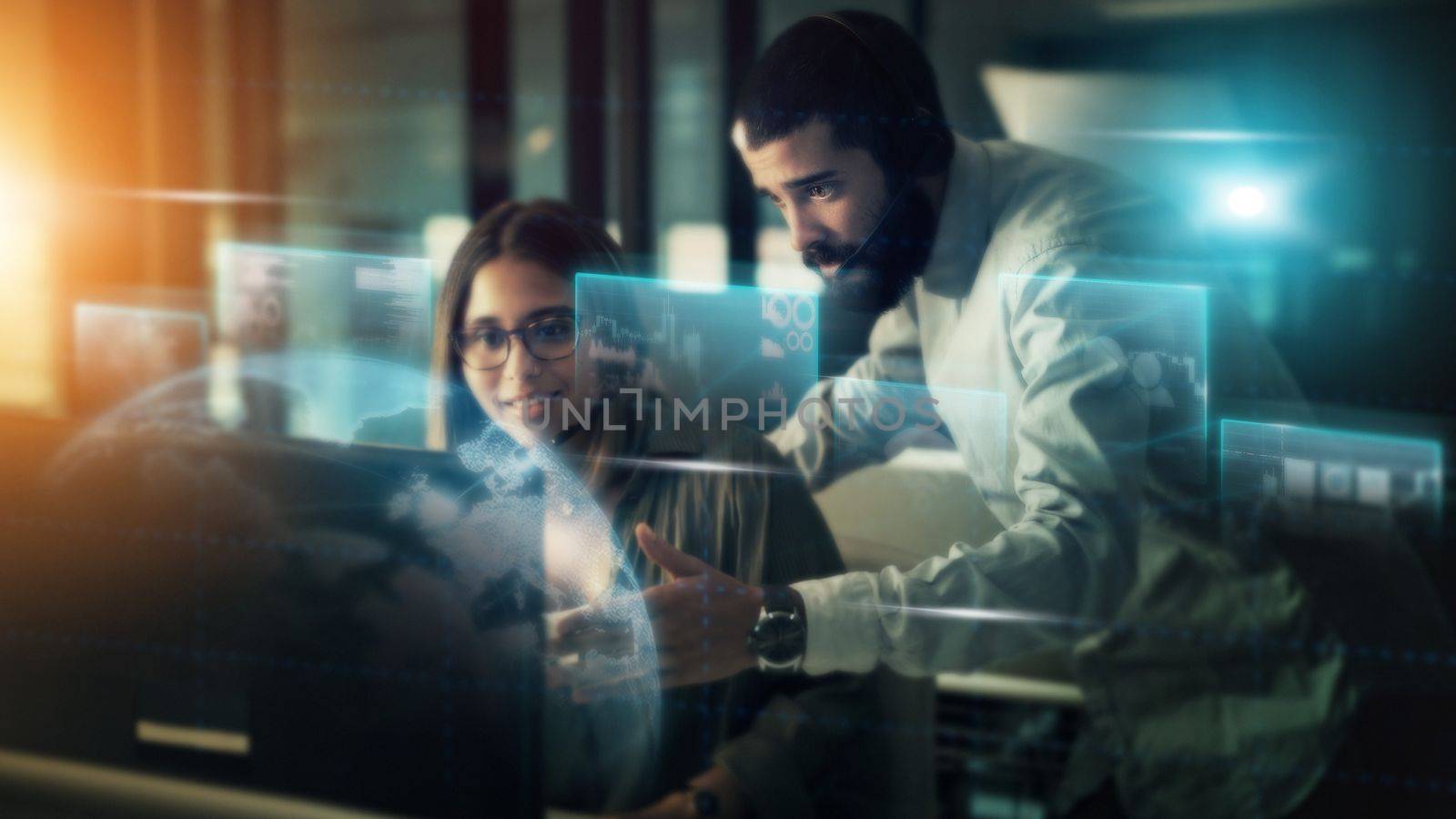 Businessman, woman and computer with overlay in night for planning, crm and coaching in futuristic office. Tech support coach, man and girl by pc for learning, 3d holographic abstract and teamwork by YuriArcurs