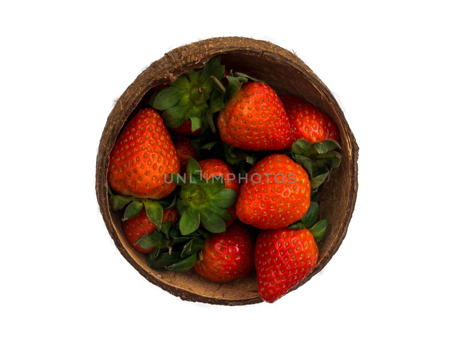 Fresh strawberries in a coconut shell on white background.