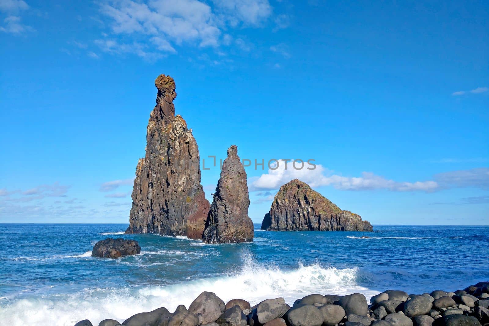 View of the rocks in the water. The waves of the sea or ocean wash the rocks