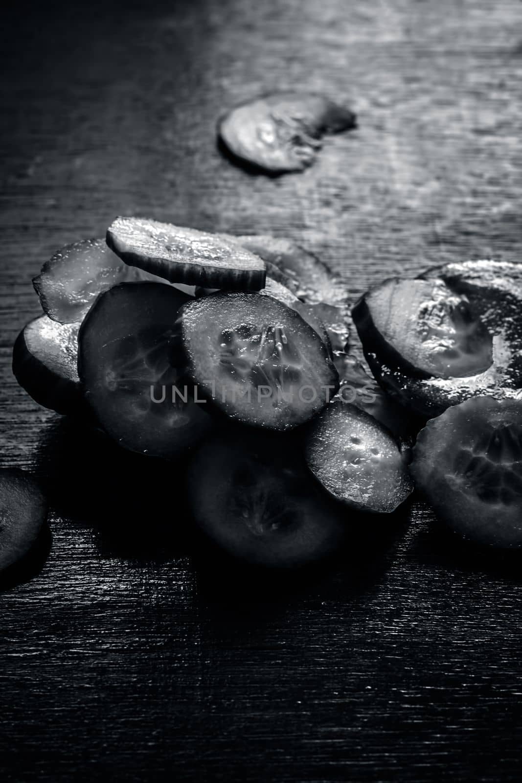 Close-up of ingredients of facial or face pack or face mask on a wooden surface i.e. slices of cucumber and Aloe Vera in dark Gothic colors for brightening and softening the skin. by mirzamlk