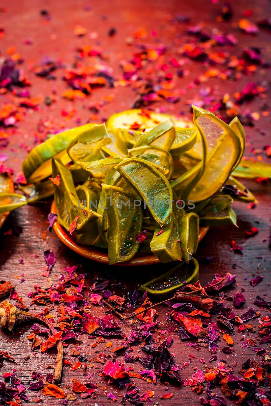 Close-up of ingredients of facial or face pack or face mask on a wooden surface i.e. slices of cucumber and Aloe Vera in dark Gothic colors for brightening and softening the skin.