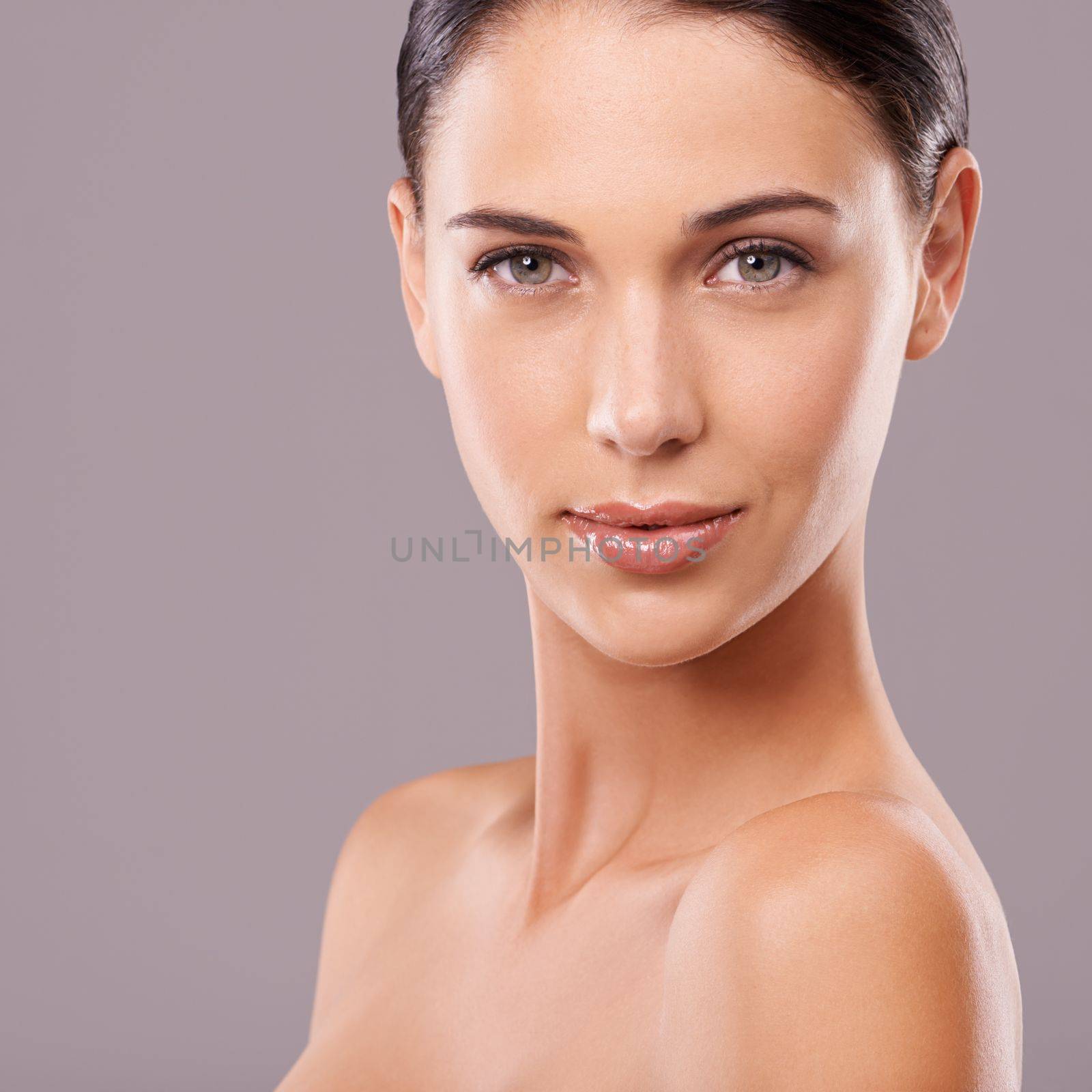Uniquely beautiful. Beauty shot of a beautiful young woman with perfect skin against a gray background
