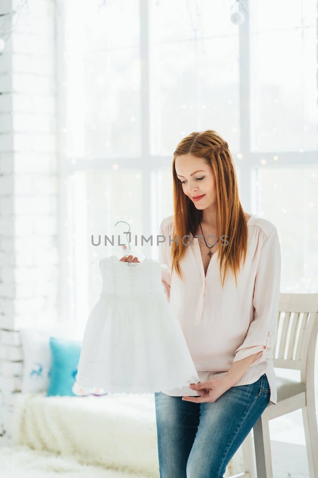 a red-haired pregnant girl in a light blouse and blue jeans by Andreua