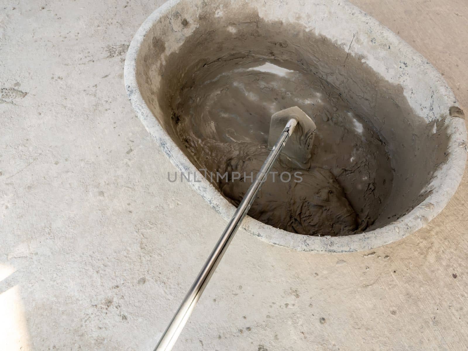 Concrete is mixed in a concrete mixing bowl