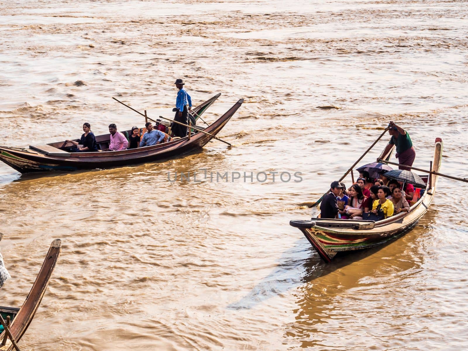 Yangon, Myanmar - Jan 4, 2020 People and tourists boarding a small boat, The only way to get to the Kyaik Hwaw Wun Pagoda and temple on a small island in the river at Kyauktan town, Yangon, Myanmar