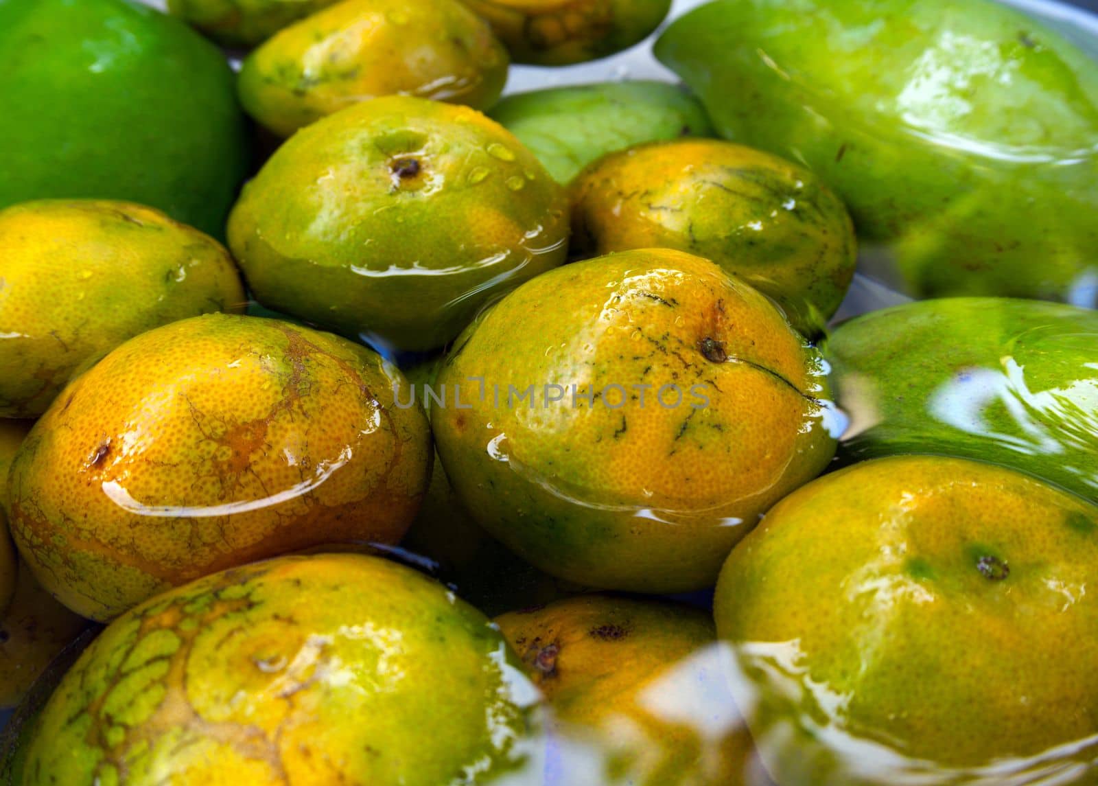 The fruits sinking and washing in water by Satakorn