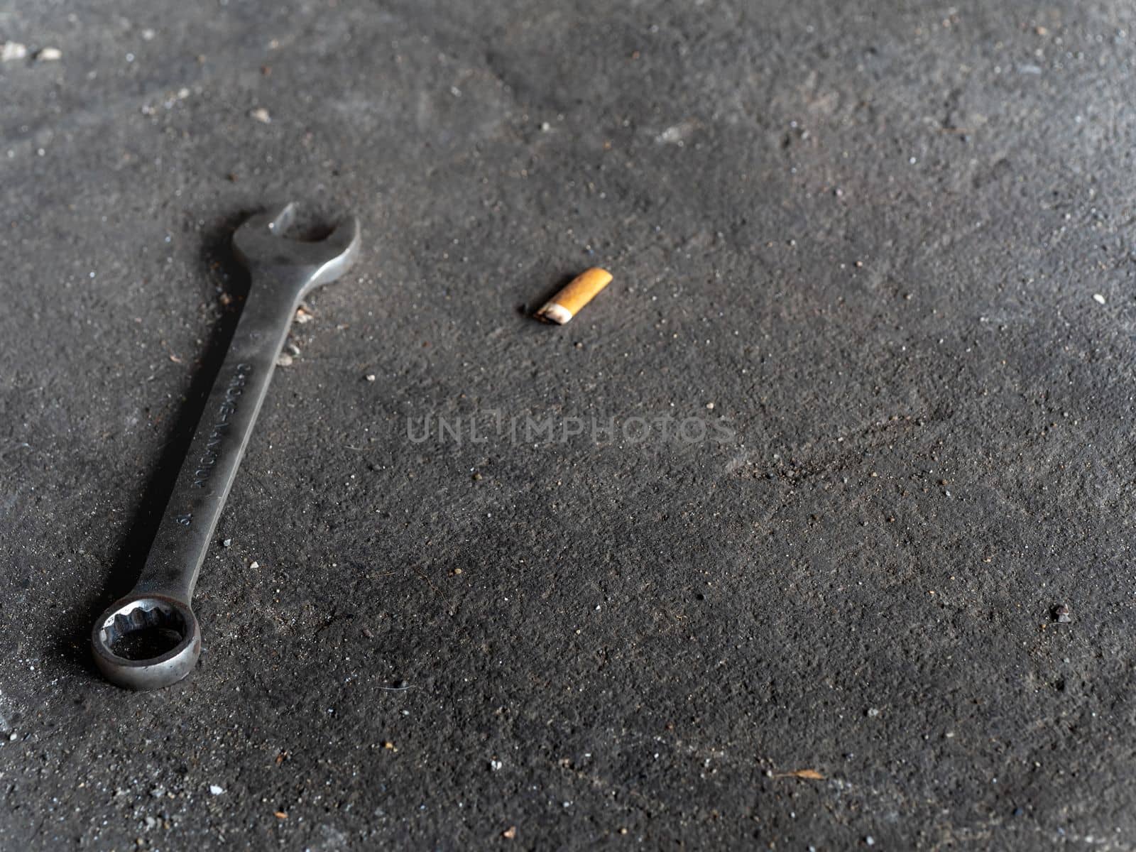 The Combination wrench on the rough concrete flooring