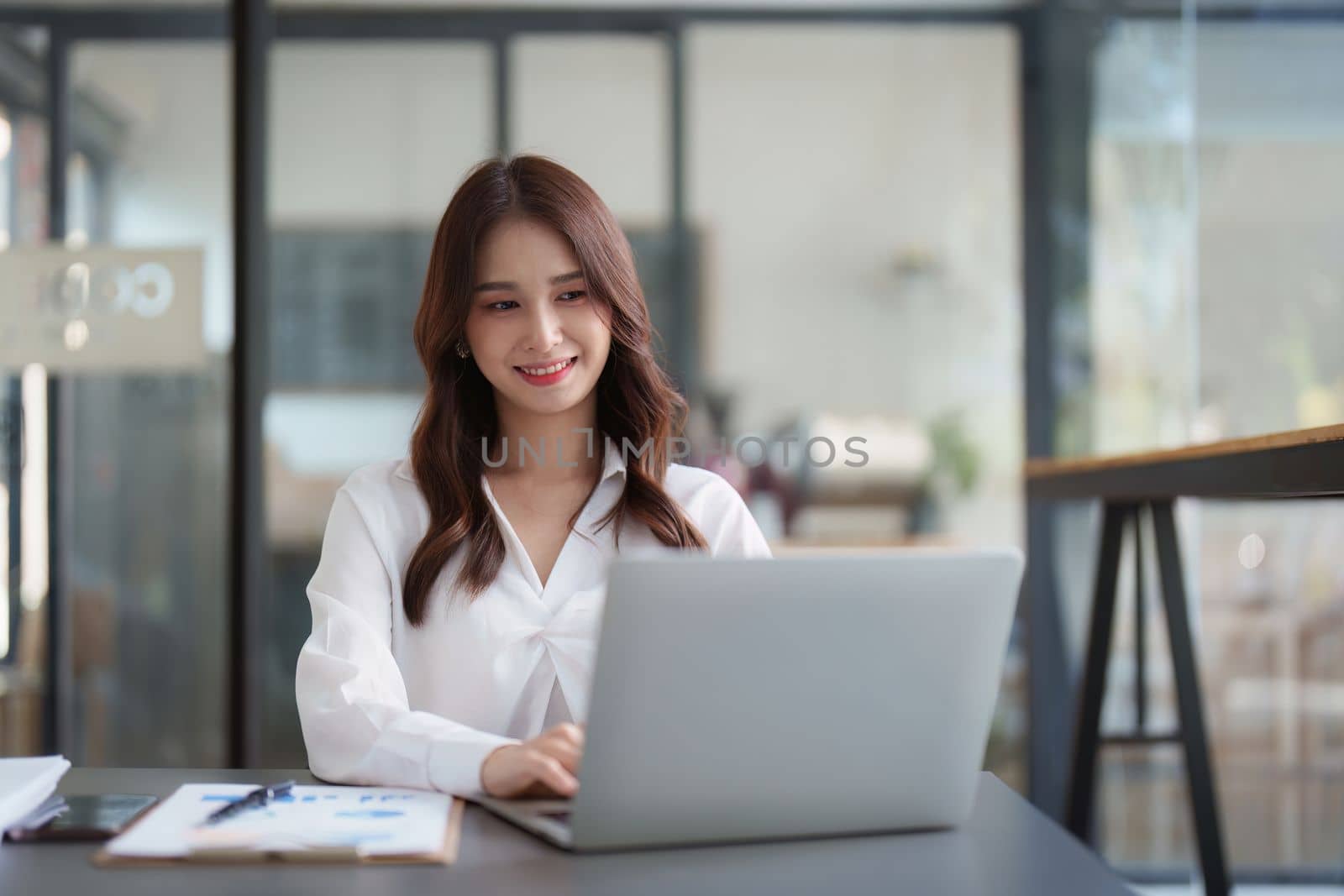 Beautiful Business woman working at home office and analyze financial report document. Accounting and Finance concept.