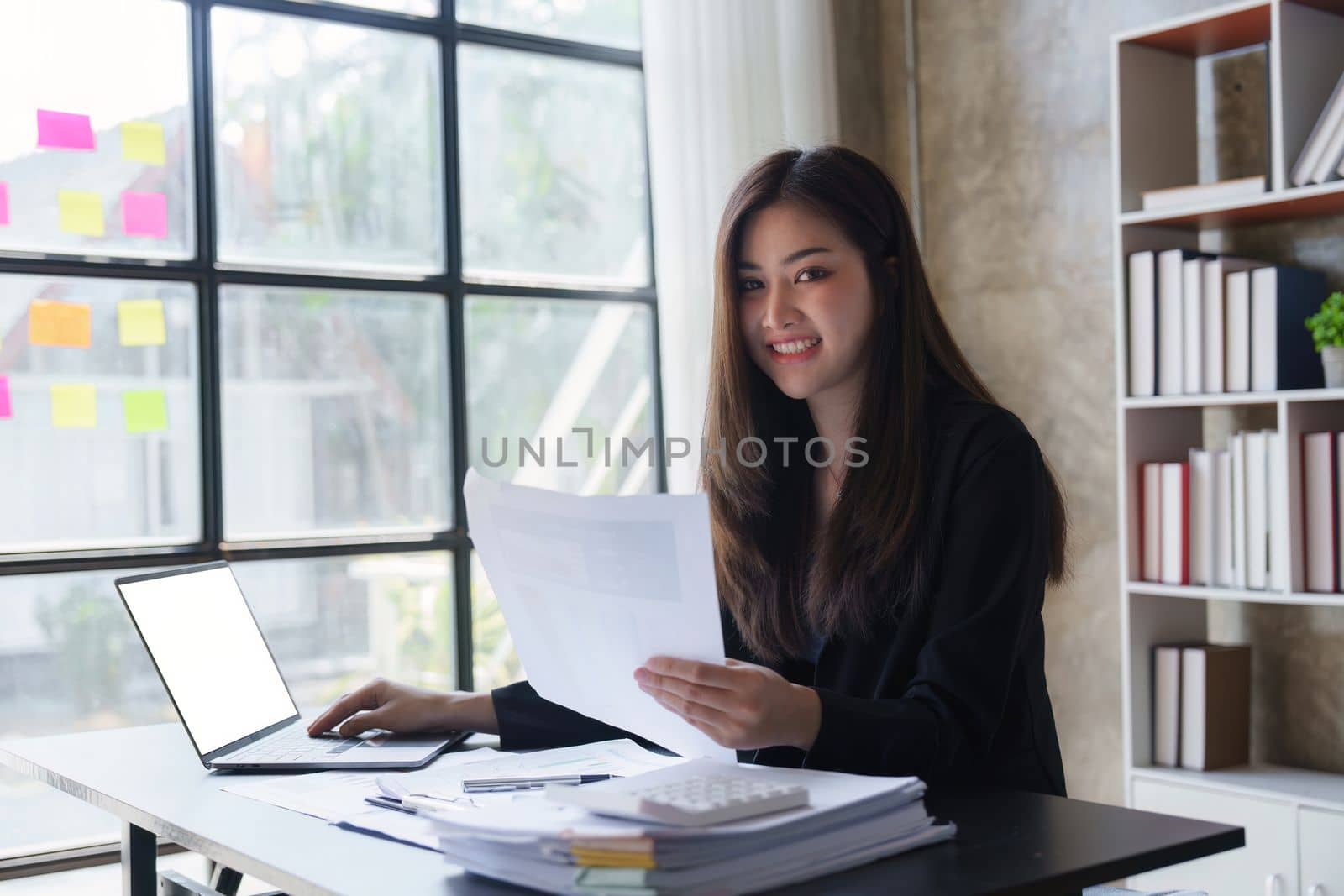 Beautiful Business woman working at home office and analyze financial report document. Accounting and Finance concept.