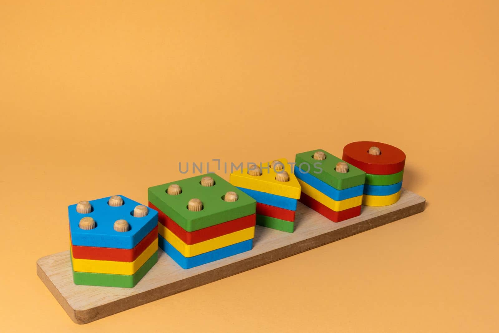 Sorter on neutral background. Multicolored logic sorter close up. Wooden educational logic toy for kid's. Montessori games for early child development