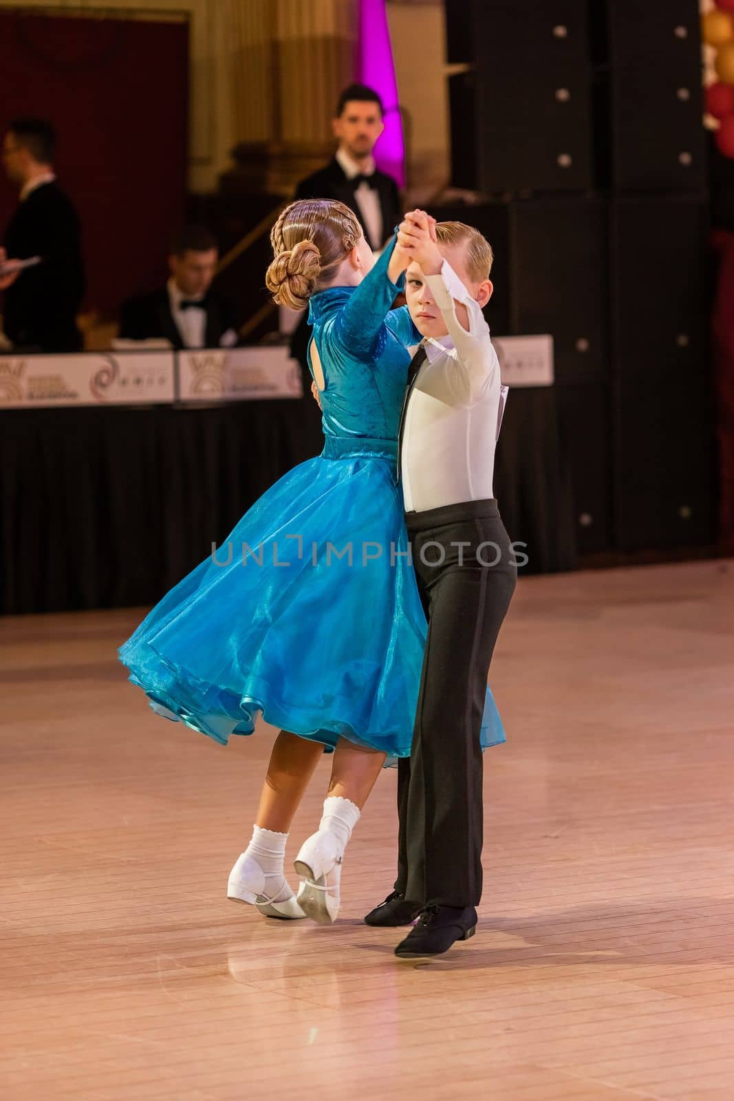 Attractive young couple of children dancing ballroom dance. Girl and boy dancer Latino international dancing.