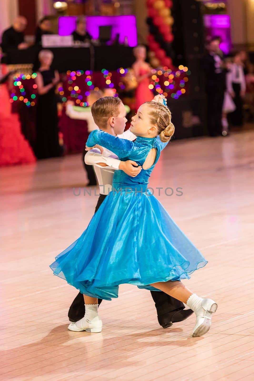 Attractive young couple of children dancing ballroom dance. Girl and boy dancer Latino international dancing.