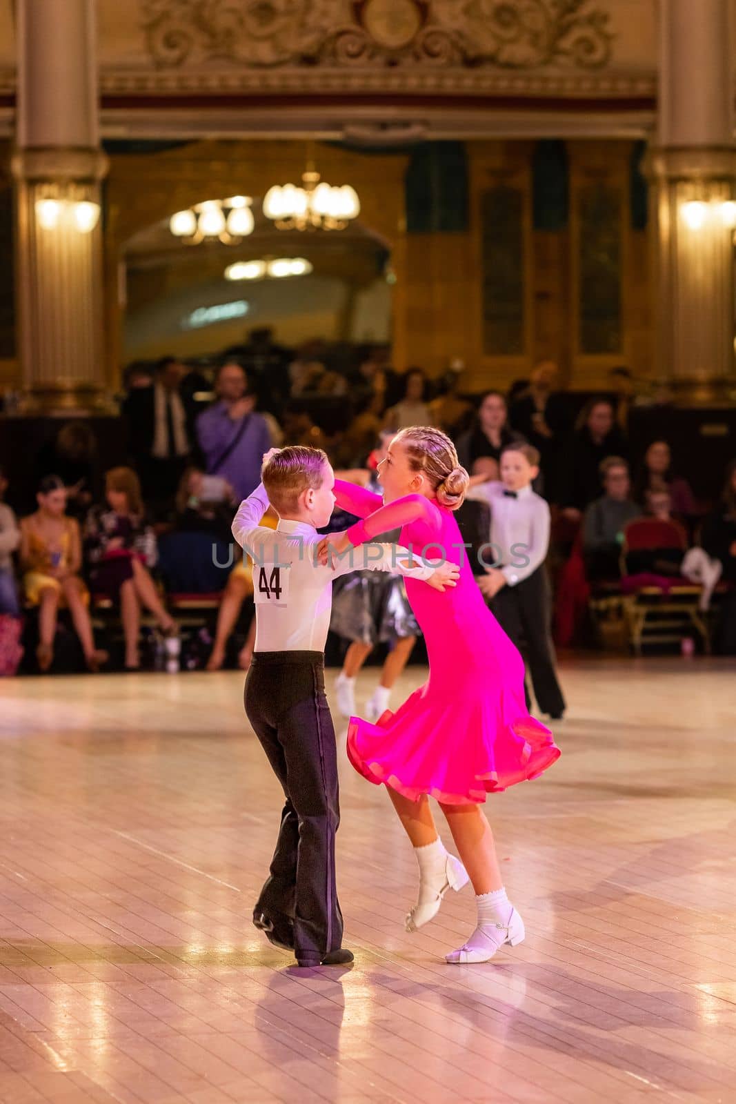 Attractive young couple of children dancing ballroom dance. Girl and boy dancer Latino international dancing.