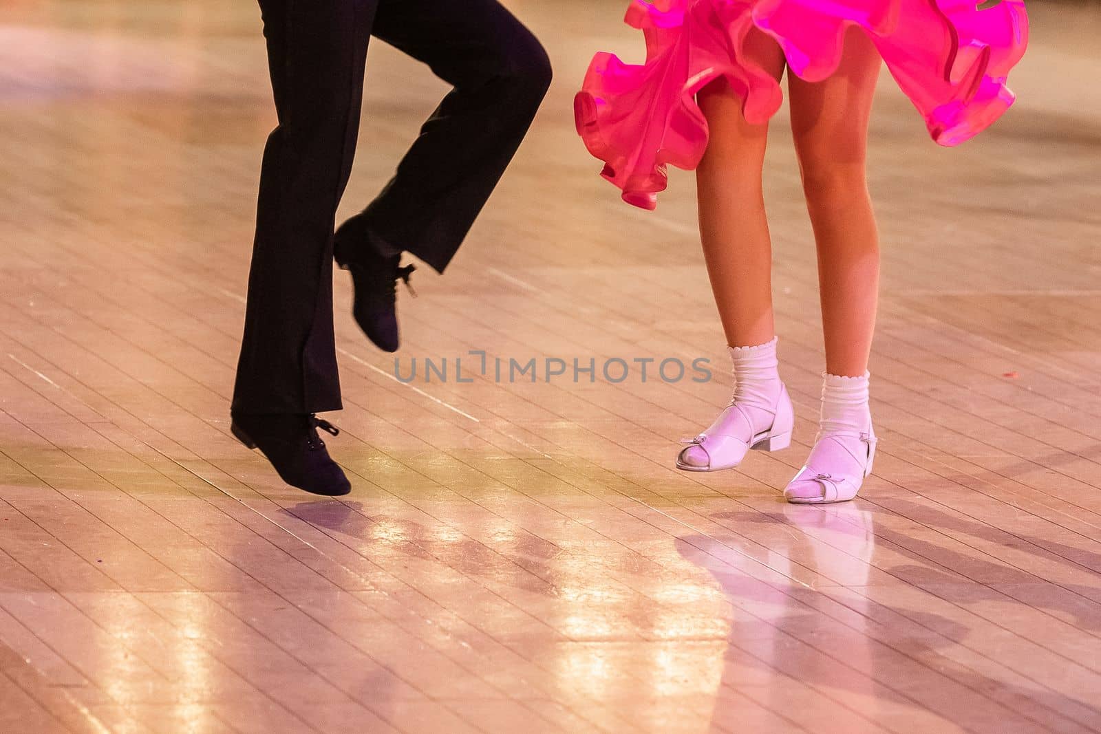 Attractive young couple of children dancing ballroom dance. Girl and boy dancer Latino international dancing.