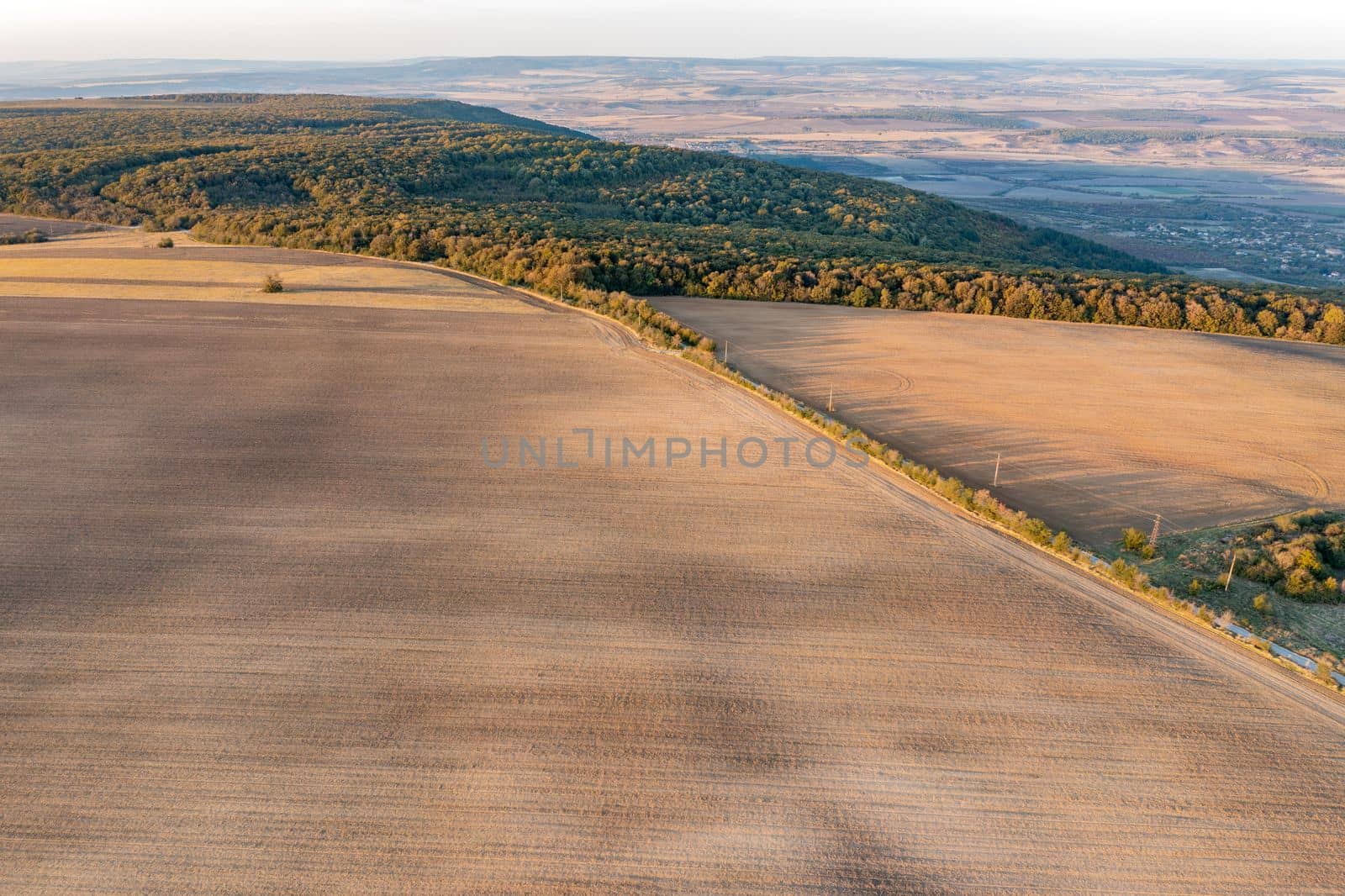 vast aerial view from drone to processed agricultural fields.