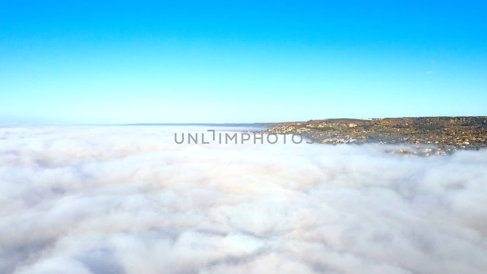 Fog clouds over the city, view from above