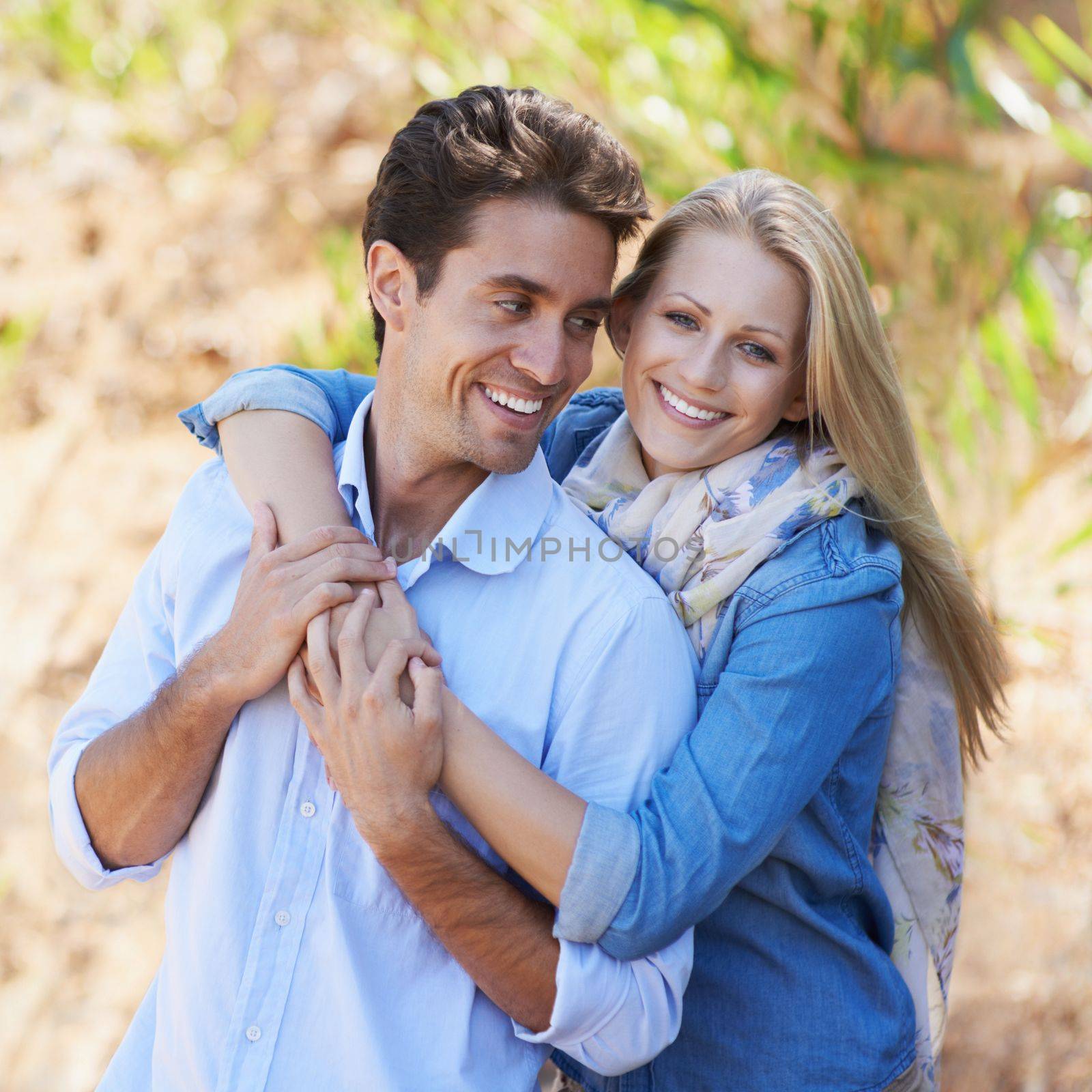 Loving every moment together. A cropped view of a romantic young couple standing together outdoors