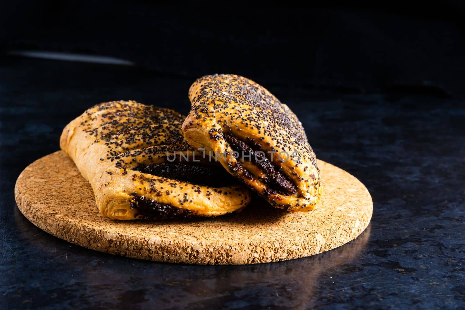 Fresh white bread and milk in white glass on a black stone table background. Top view, croissant