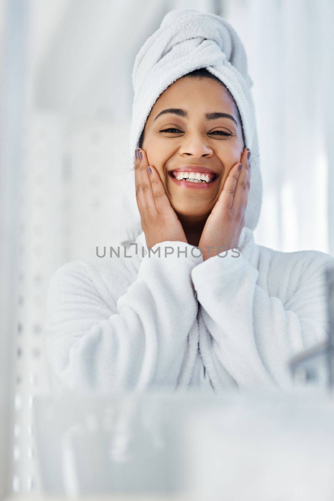 Beauty personified. a young woman going through her beauty routine at home. by YuriArcurs