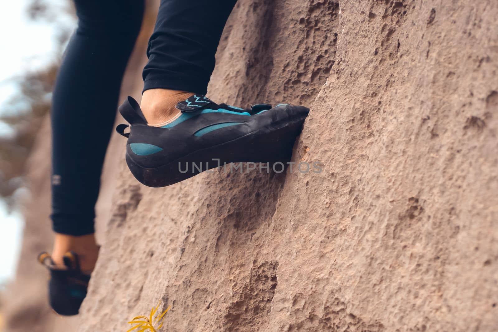 Woman is climbing, training on the mountains, feets closeup. by africapink