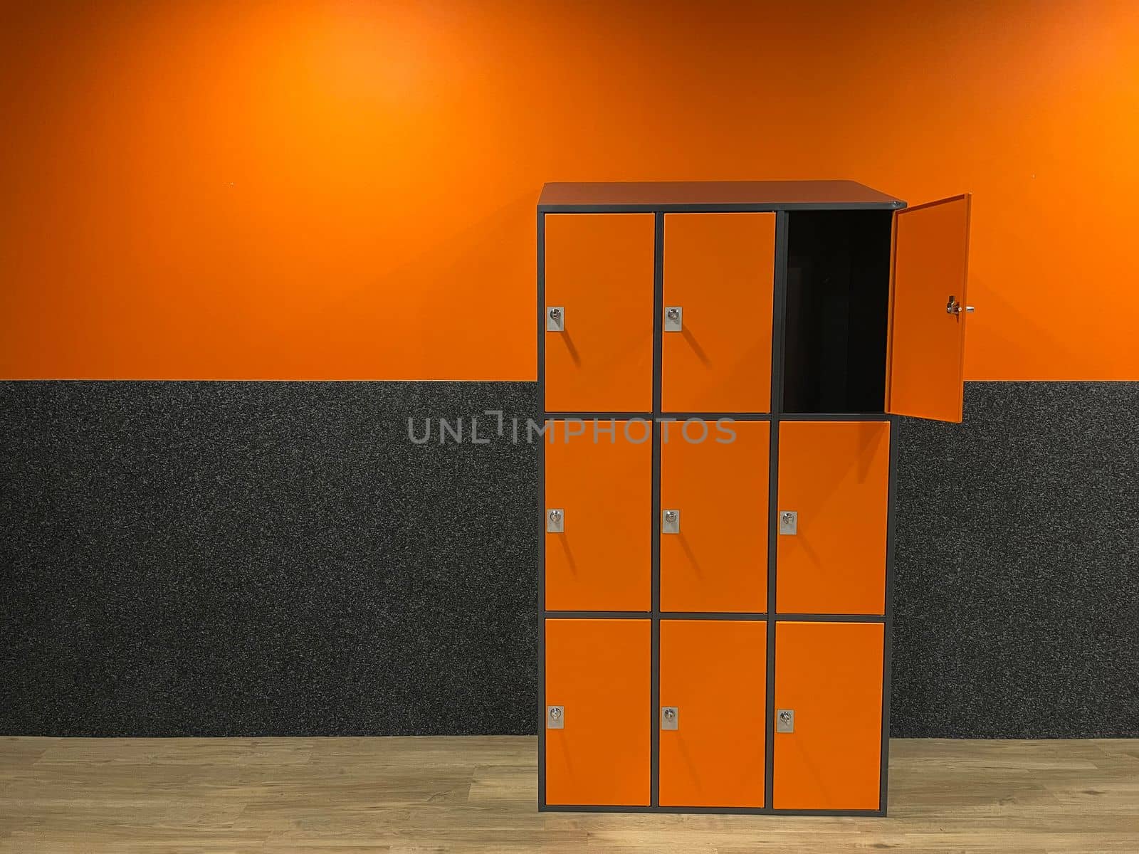 dressing room in the gym with orange-gray cement walls locker room for athletes. High quality photo