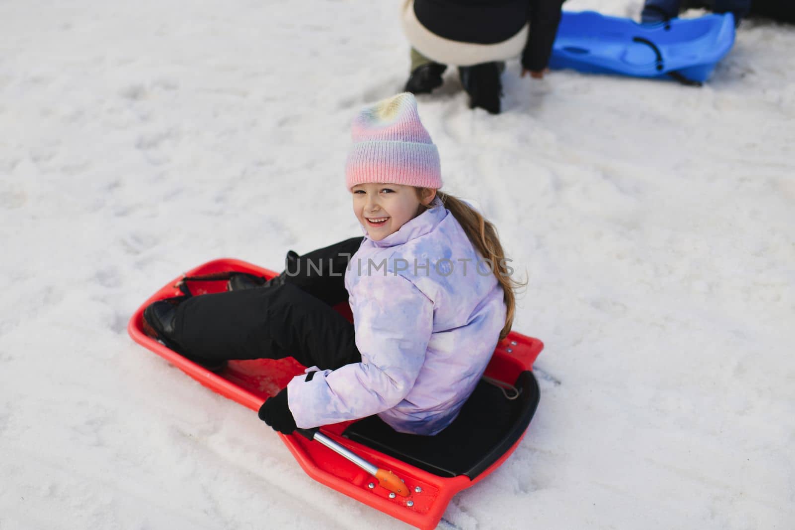 A girl with bob sledding in the snow