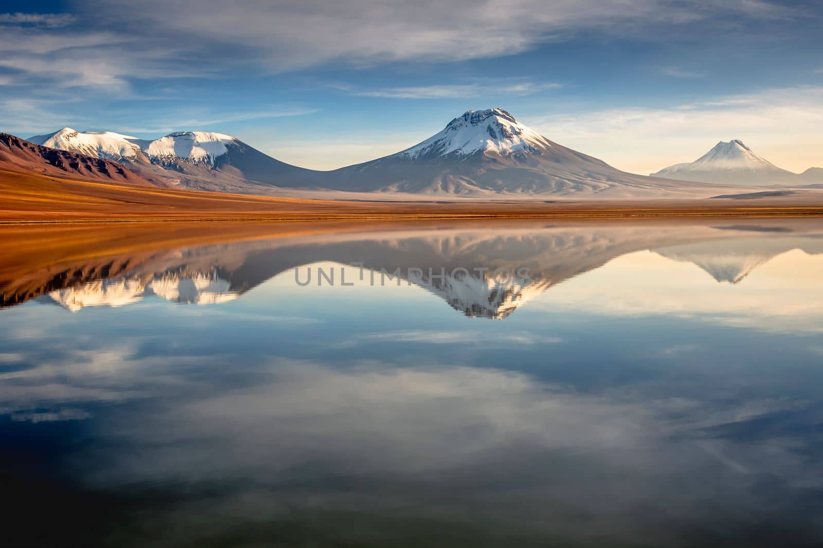 Salt lake Lejia reflection and idyllic volcanic landscape at Sunset, Atacama desert, Chile