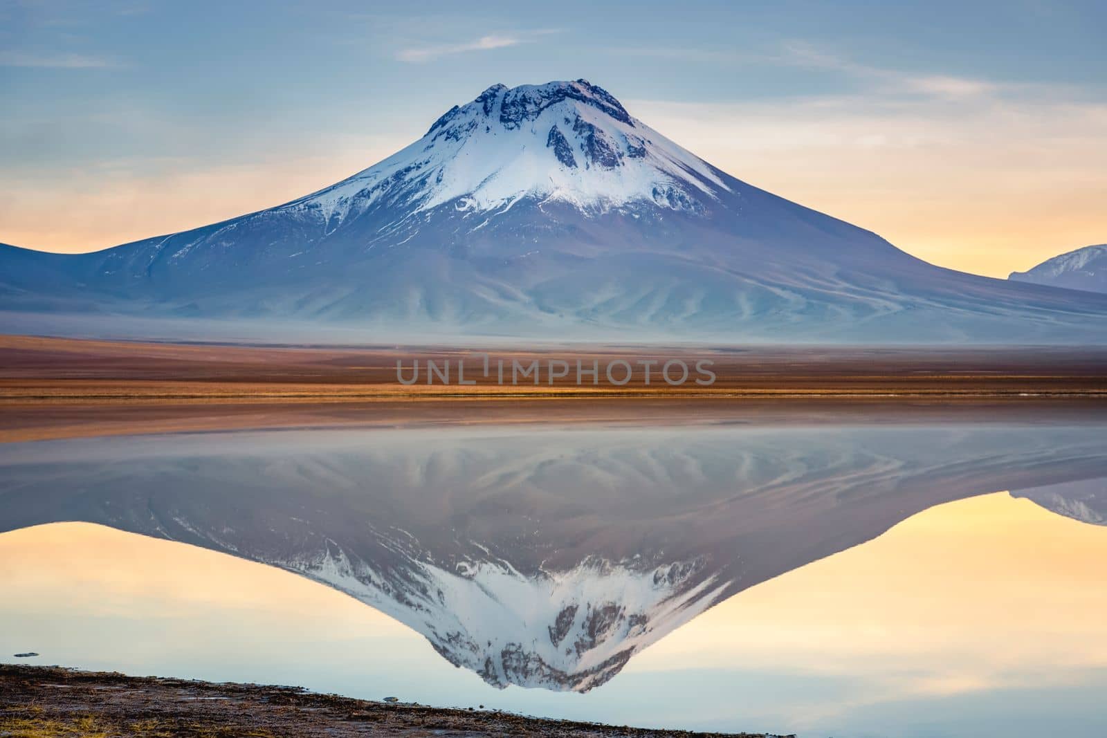 Salt lake Lejia reflection and idyllic volcanic landscape at Sunset, Atacama desert, Chile